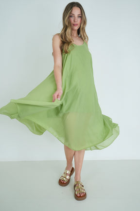Woman wearing a green dress against a white background