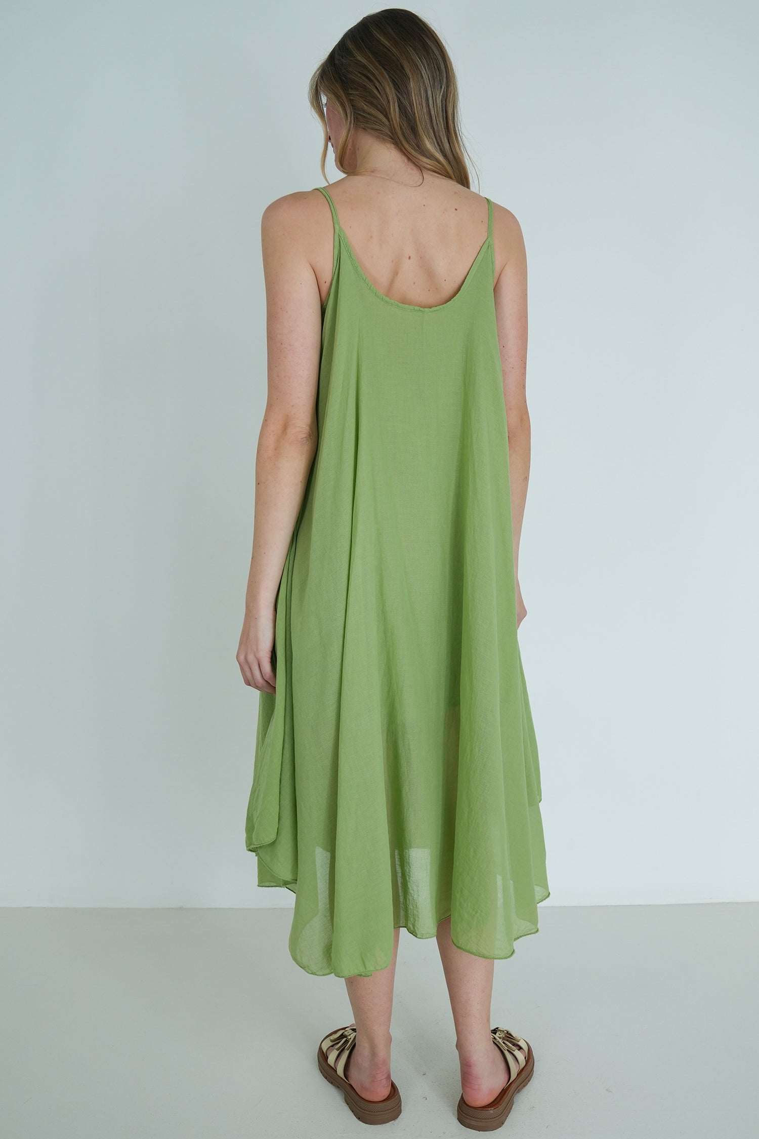 Woman wearing a green dress against a white background