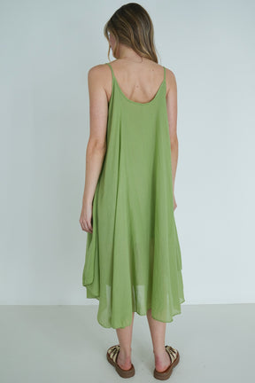 Woman wearing a green dress against a white background