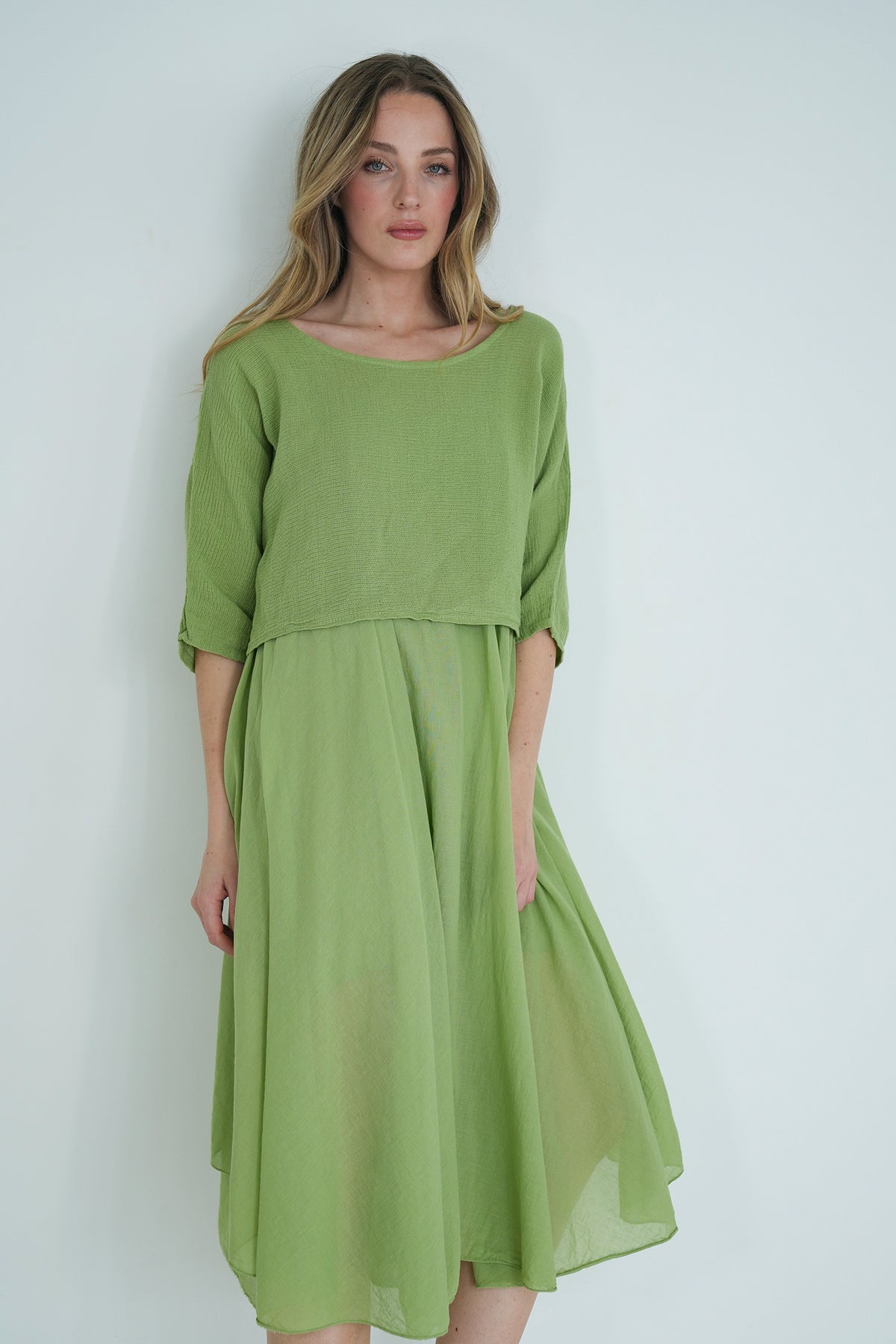 Woman wearing a green dress against a white background