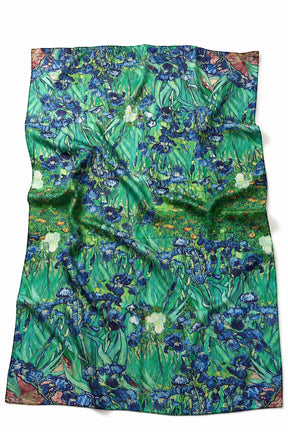 A square scarf featuring a detailed print of Van Gogh's 'Irises Field' in vibrant green, blue, and white tones, laid flat against a white background.