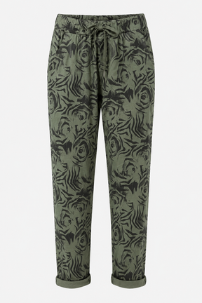A pair of olive green drawstring trousers featuring an all-over black tiger print, shown against a plain light gray background.