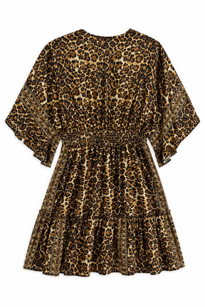 A short tiered dress with a leopard print pattern in brown, black, and beige, featuring a smocked waist and elbow-length sleeves, shown against a plain white background.