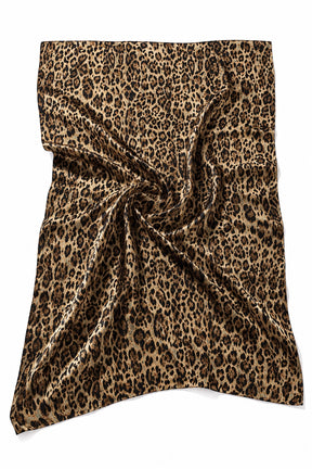 A leopard print scarf draped in a swirl pattern on a solid white background.