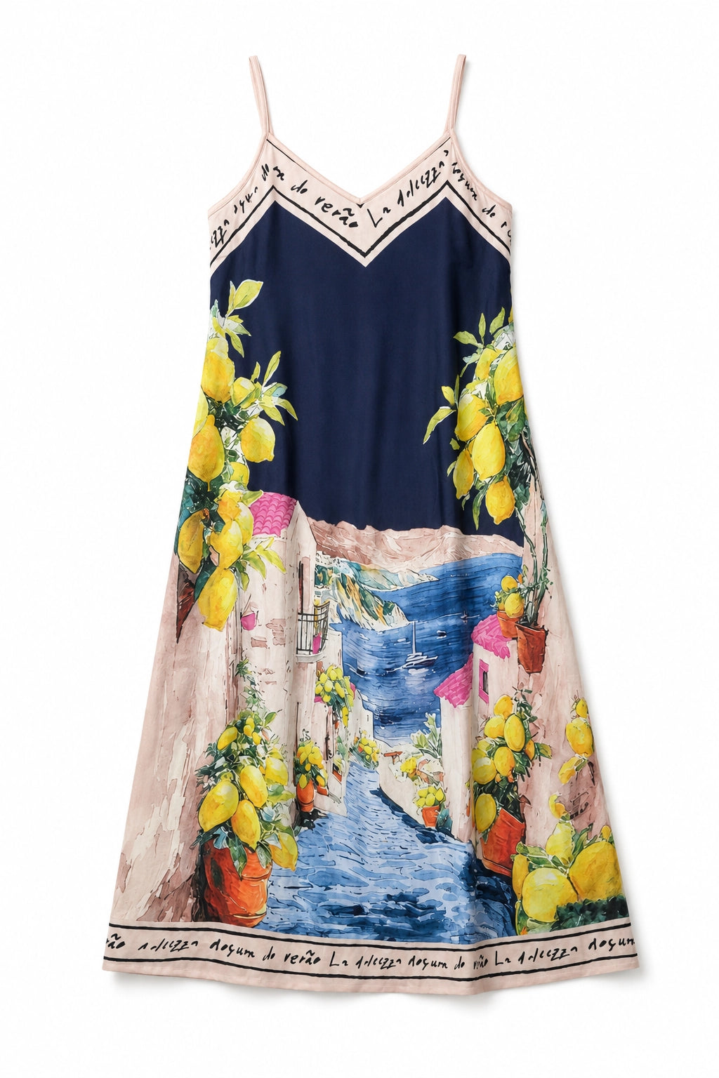 A sleeveless spaghetti-strap dress featuring a colorful Mediterranean coastal scene with lemon trees, white buildings, and a blue sea, set against a dark navy background.