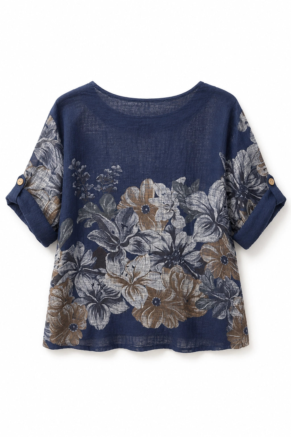 A women's short-sleeve top in navy blue linen fabric, featuring a large floral print in beige, gray, and white. The sleeves have rolled cuffs with two decorative gold buttons.