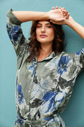 Woman wearing a floral shirt against a blue background