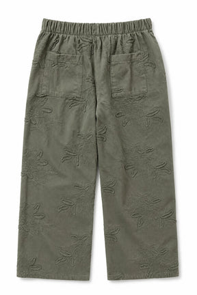 Olive green cropped pants with an all-over tonal floral jacquard pattern, featuring an elastic waistband and two front patch pockets.
