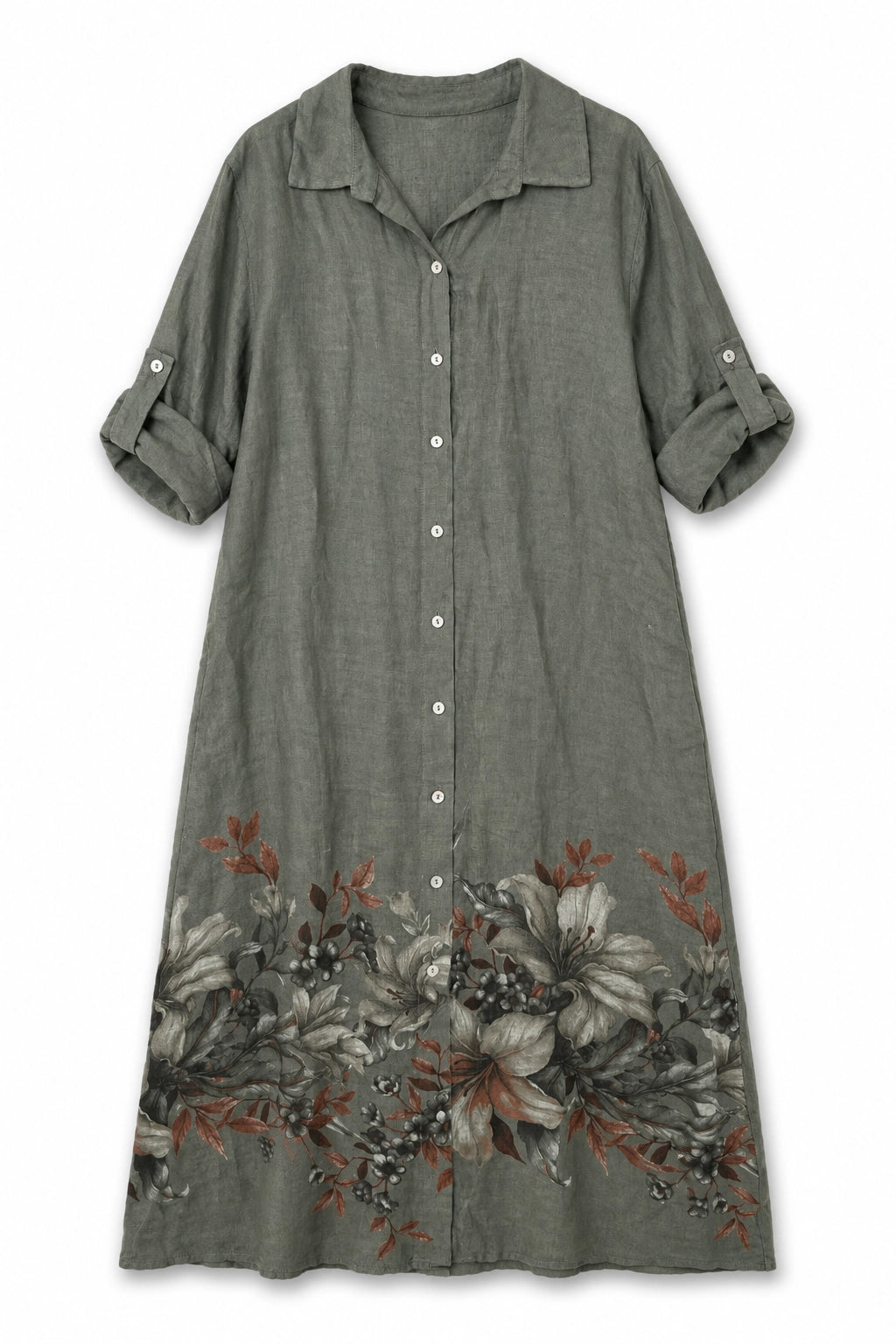 A women's short-sleeve button-up shirt dress in a muted sage green fabric, featuring a collar, white buttons, and a floral print in gray, black, and rust orange along the bottom hem.