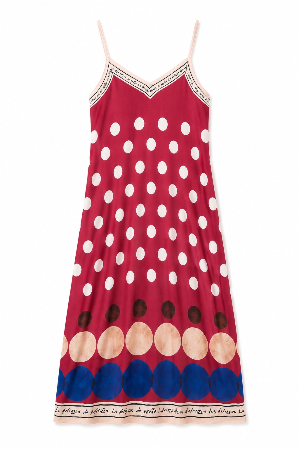 A red spaghetti-strap dress featuring a white polka-dot pattern, a row of large beige and blue circles near the hem, and a black-and-white patterned border trim.