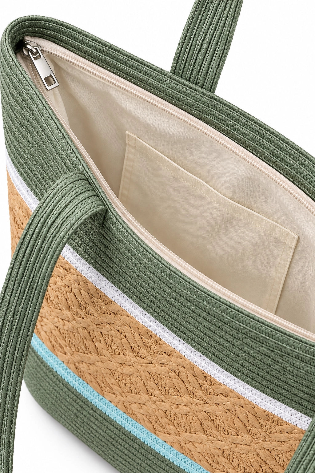 Close-up of a woven tote bag with green braided trim, a tan woven band, thin white and light blue stripes, and a cream interior pocket and lining.