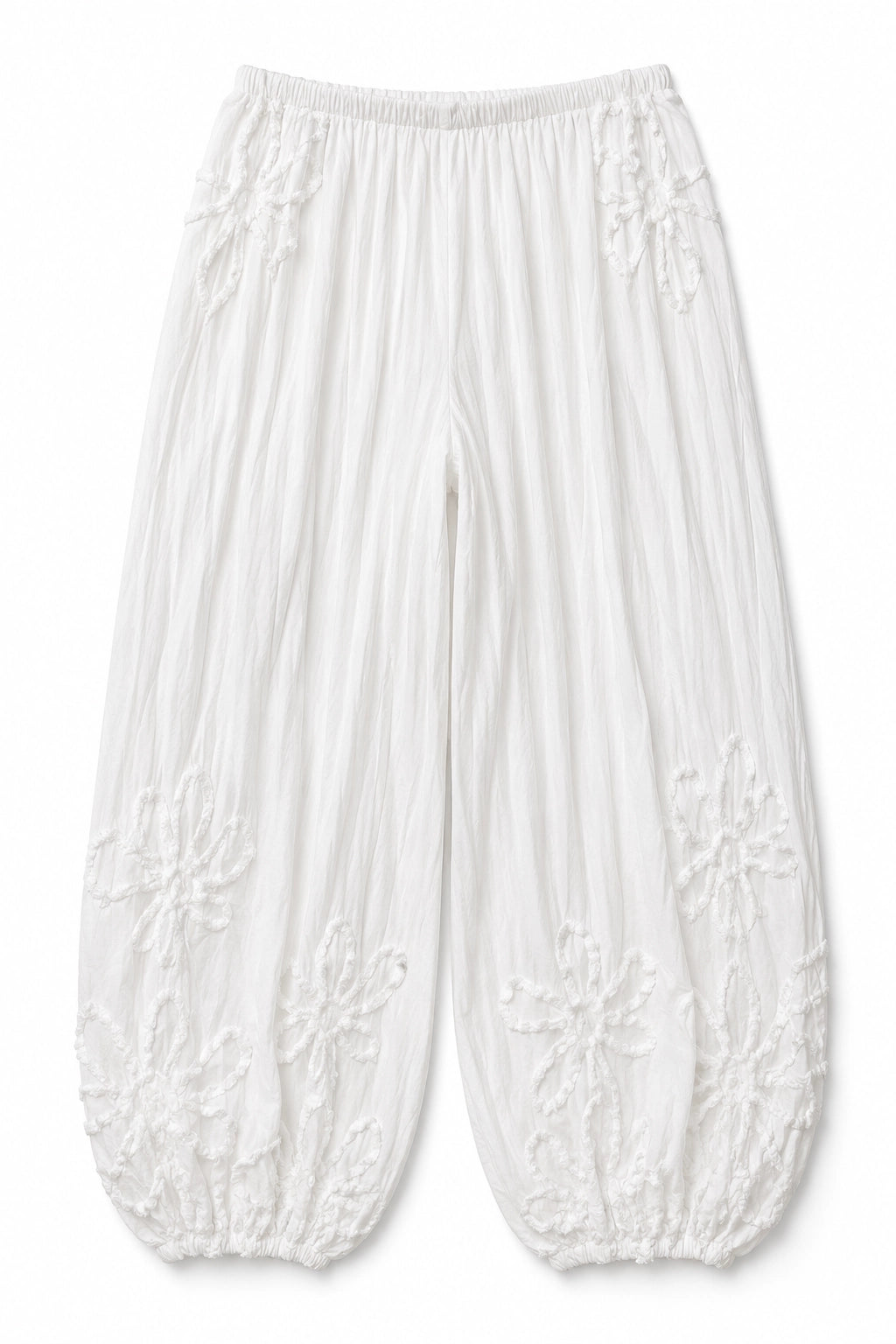 White crinkled cotton pants with embroidered floral patterns and elasticated cuffs, shown flat on a white background.