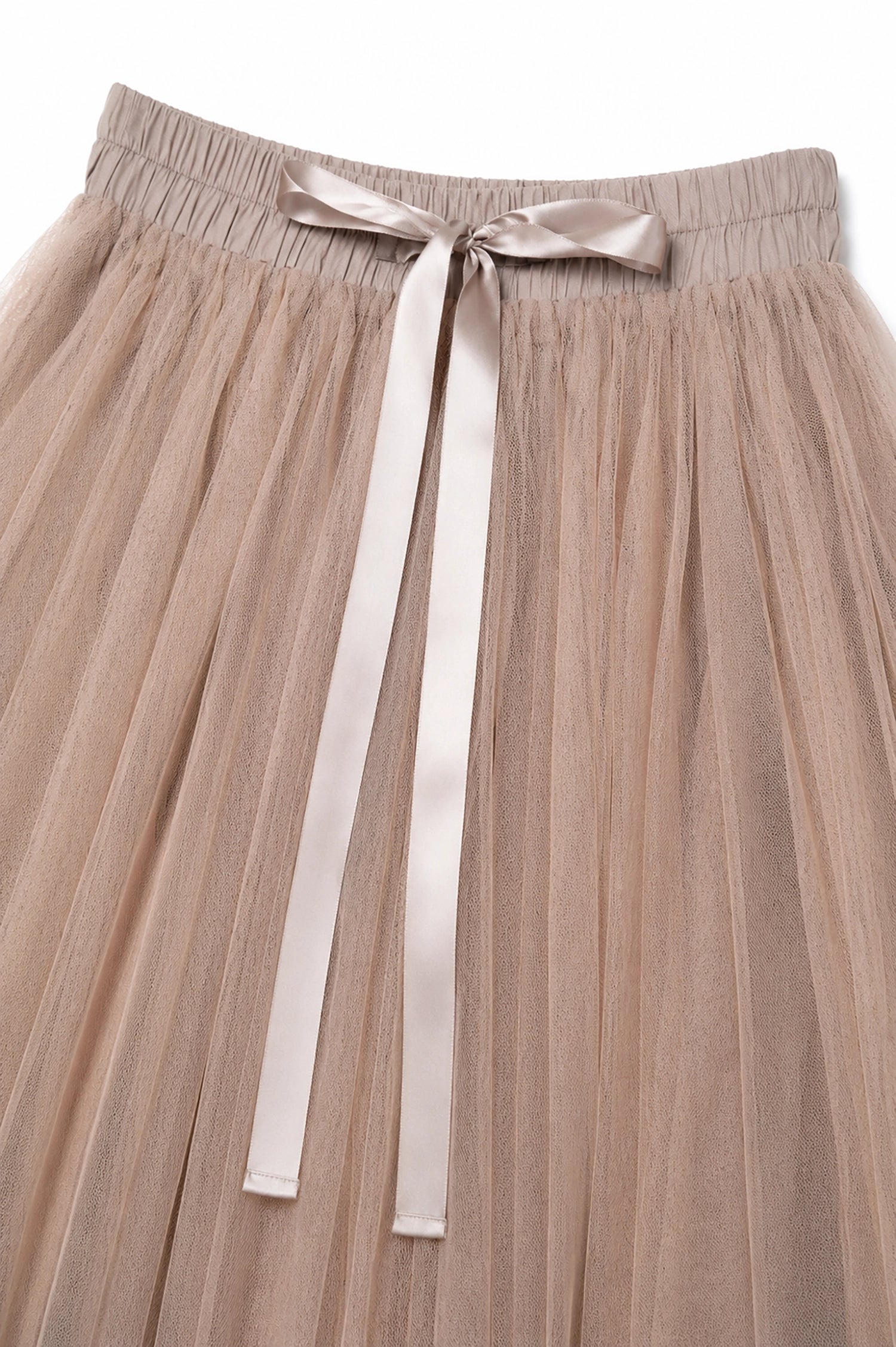Beige pleated skirt with a ribbon waistband on a light background