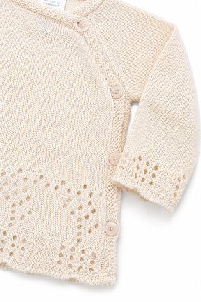 Beige baby cardigan with lace details on a white background