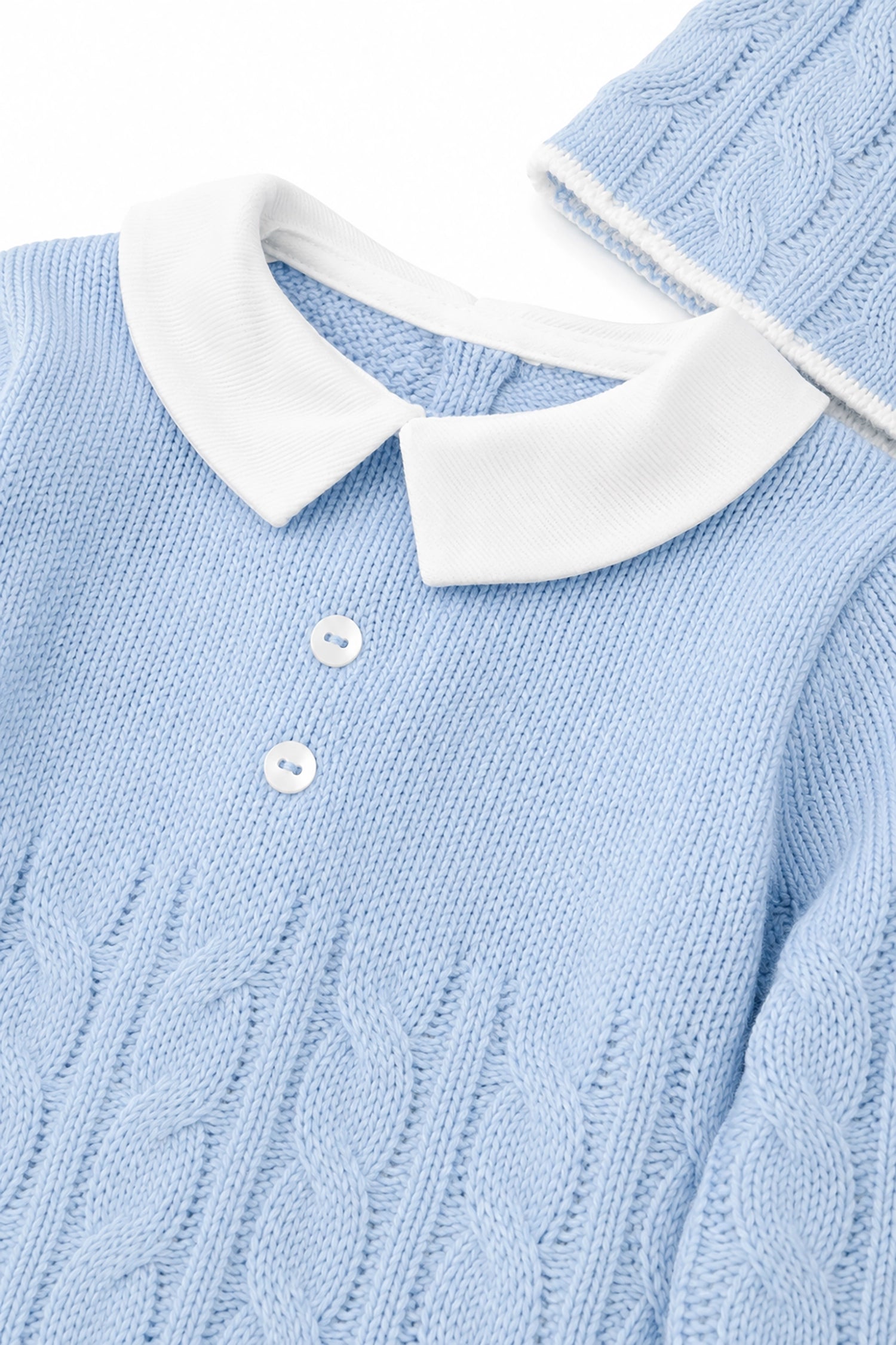 Light blue sweater with white collar and buttons on a white background