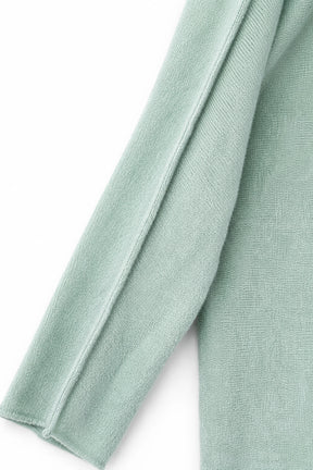 Close-up of light green fabric on a white background
