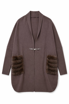 Brown coat with fur patches on a white background