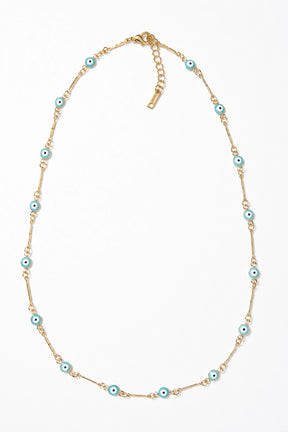 Gold necklace with blue beads on a white background