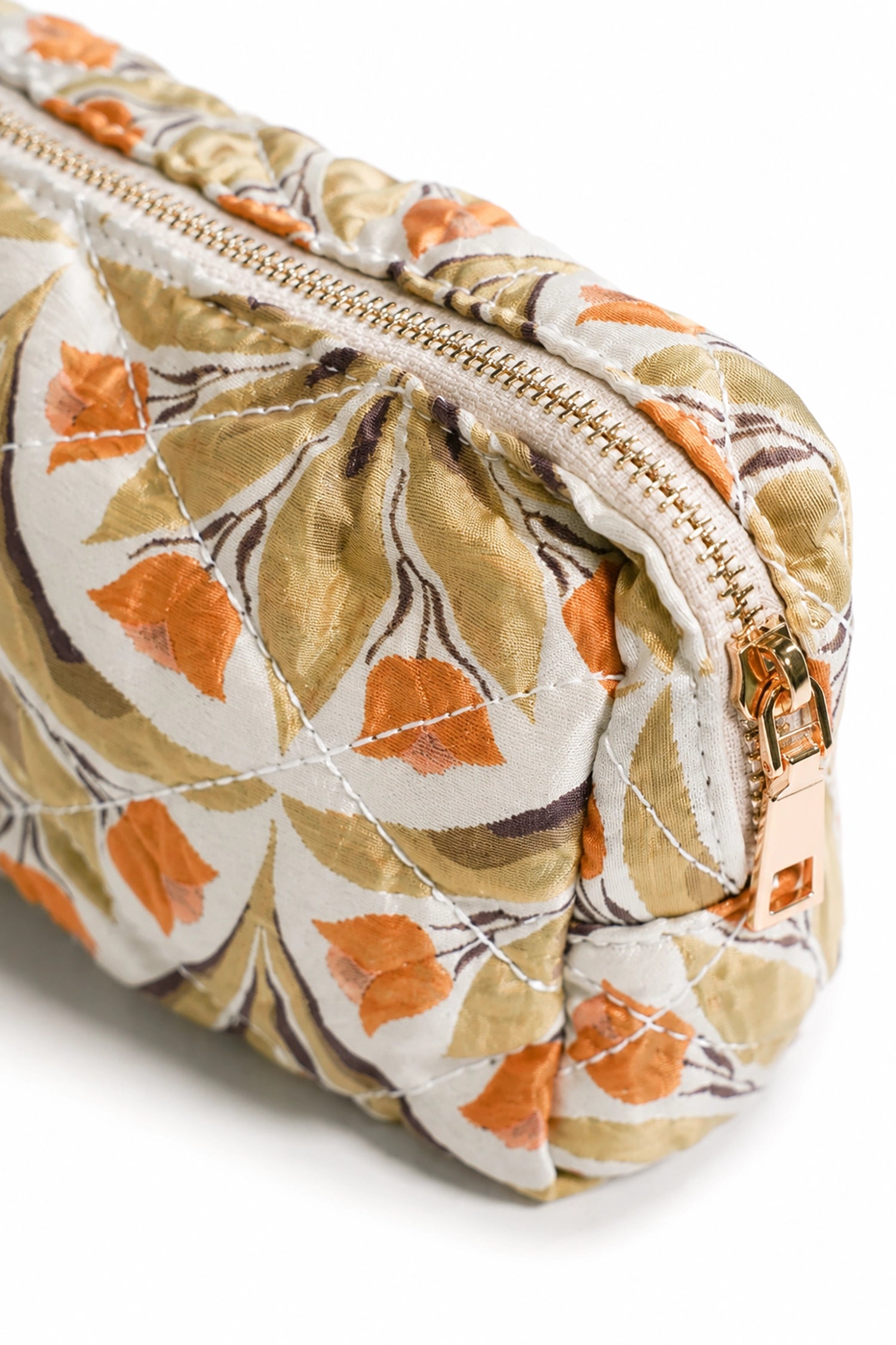 Floral-patterned makeup bag with a gold zipper on a white background