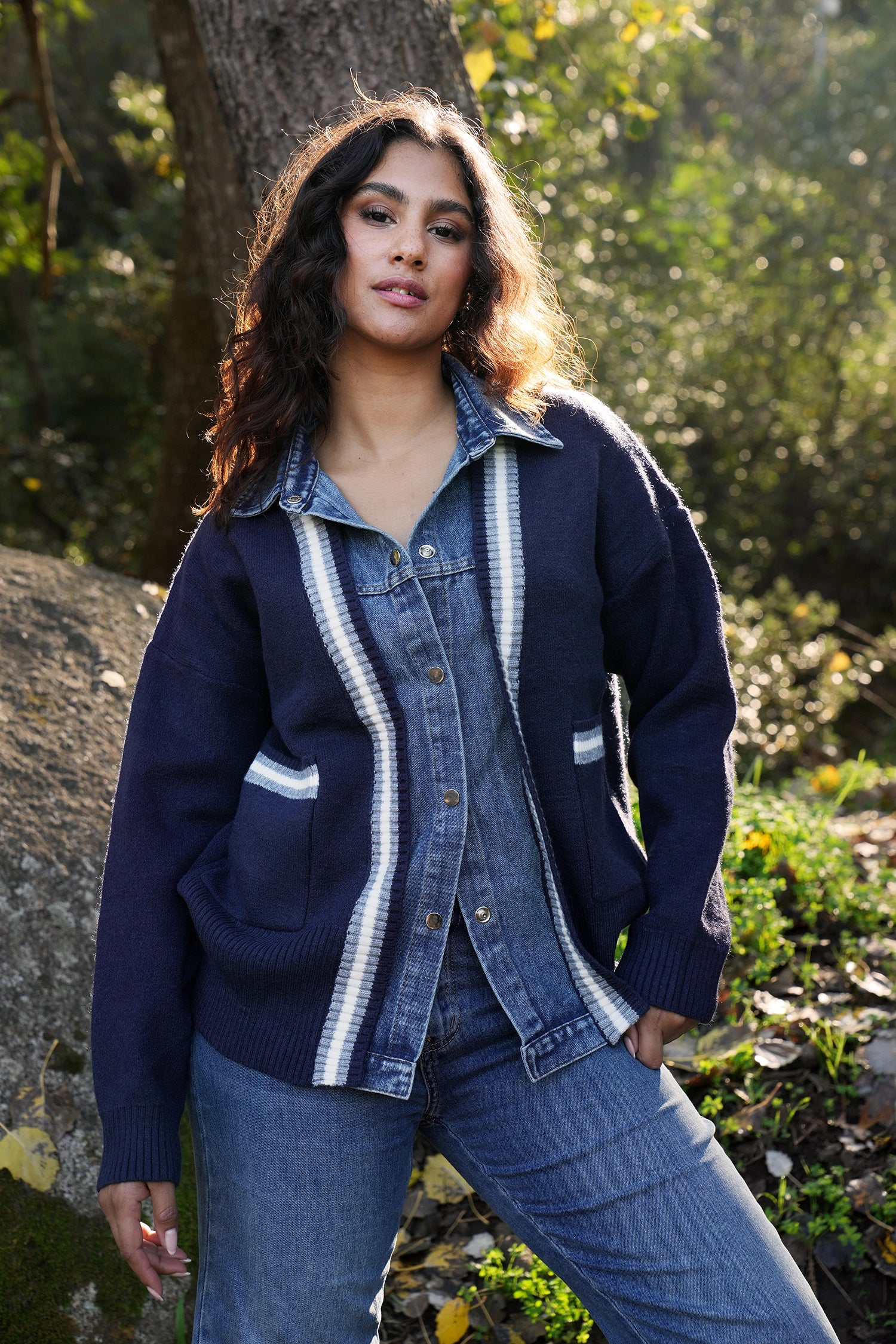 Woman wearing a blue denim jacket with white stripes outdoors