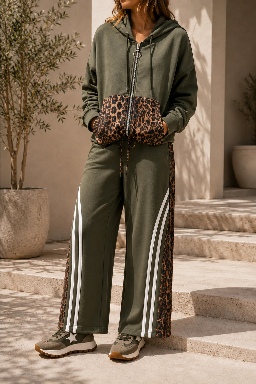 Person wearing a green tracksuit with leopard print accents outdoors.
