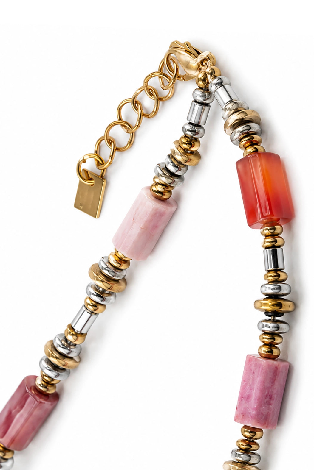 Necklace with pink beads and gold, silver, and red accents on a white background