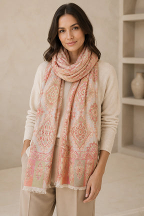 Woman wearing a patterned scarf in a neutral setting
